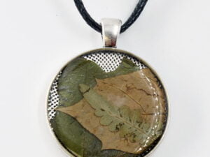 Obesek s pravimi rastlinami v epoksi smoli s povoskanim črnim bombažnim trakom in drsnimi vozli.